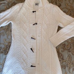 Pretty cream sweater with unique buttons.